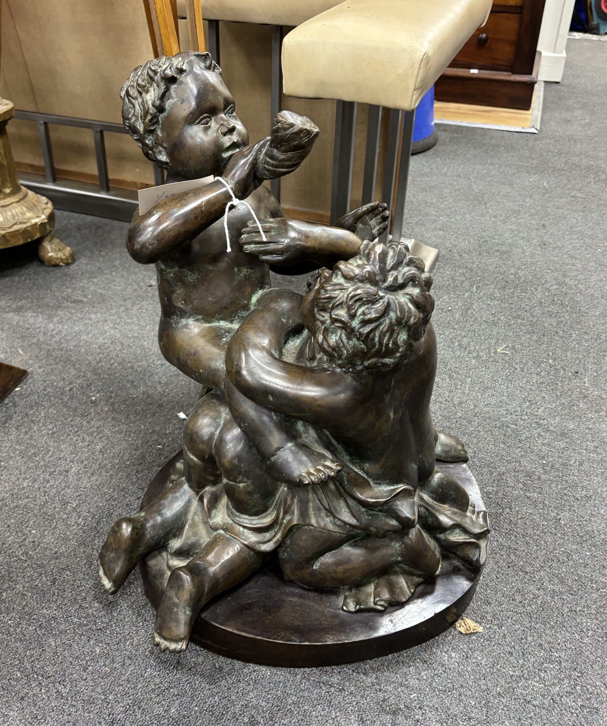An early 20th century large bronze cherubic figure group, 52cm